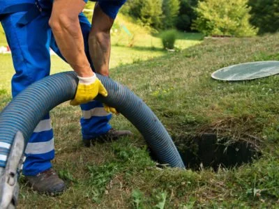 Emptying household septic tank. Cleaning sludge from septic system.