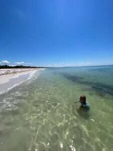 person swimming on a beach on north captiva