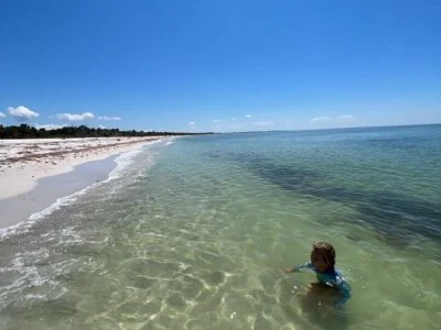 person swimming on a beach on north captiva