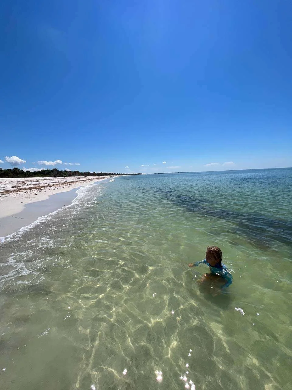 person swimming on a beach on north captiva