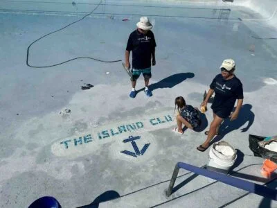 People working on the island club's main pool near mango's bar and grill